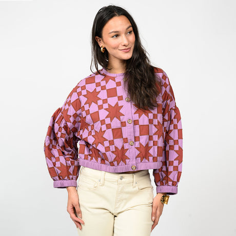 Woman wearing a patterned sweater with a white background