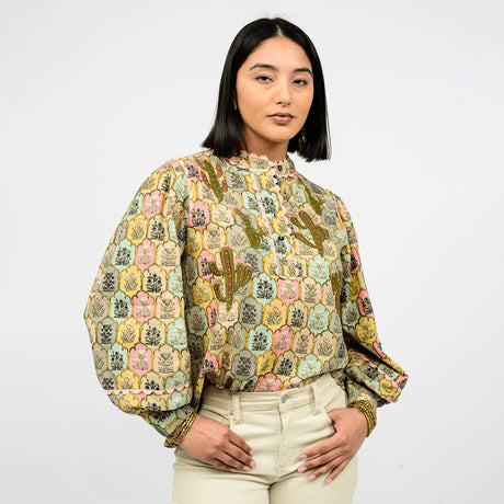 Woman wearing a patterned blouse with a white background