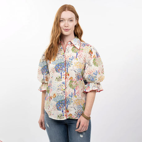 Woman wearing a colorful patterned shirt on a white background
