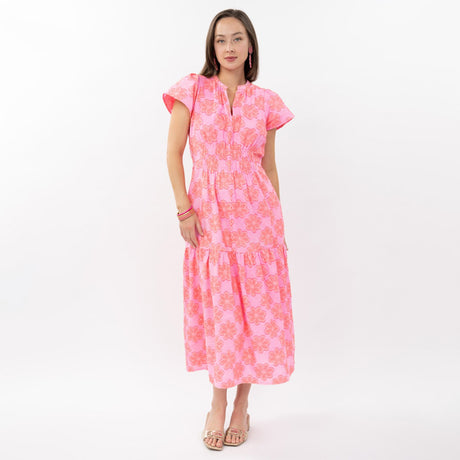 Woman wearing a pink floral dress on a white background