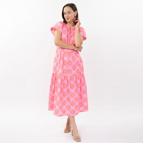 Woman wearing a pink floral dress on a white background