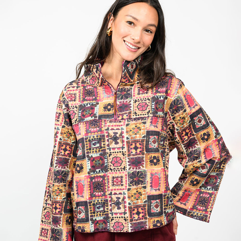 Woman wearing a colorful patterned jacket on a white background