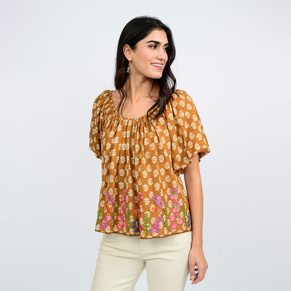 Woman wearing a floral blouse with a plain background