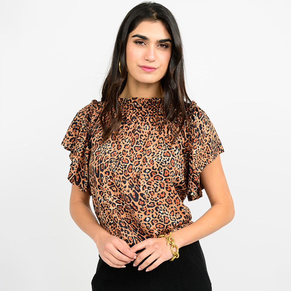 Woman wearing a leopard print blouse on a white background