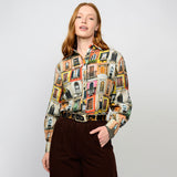 Woman wearing a colorful patterned shirt with a plain background