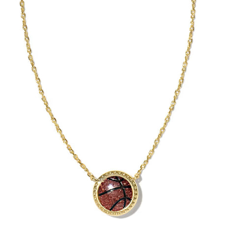A delicate gold chain necklace with a small oval pendant featuring a reddish-brown stone surrounded by a gold border, displayed on a clean white background.