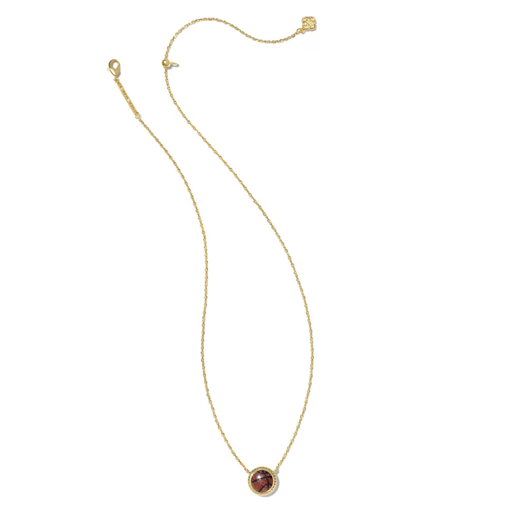 A delicate gold chain necklace with a small oval pendant featuring a reddish-brown stone surrounded by a gold border, displayed on a clean white background.