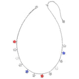 A silver-toned chain necklace with multiple dangling star charms, including three red stars and two blue stars on a plain white background.