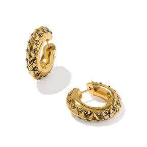 Gold hoop earrings with pyramid designs on a white background