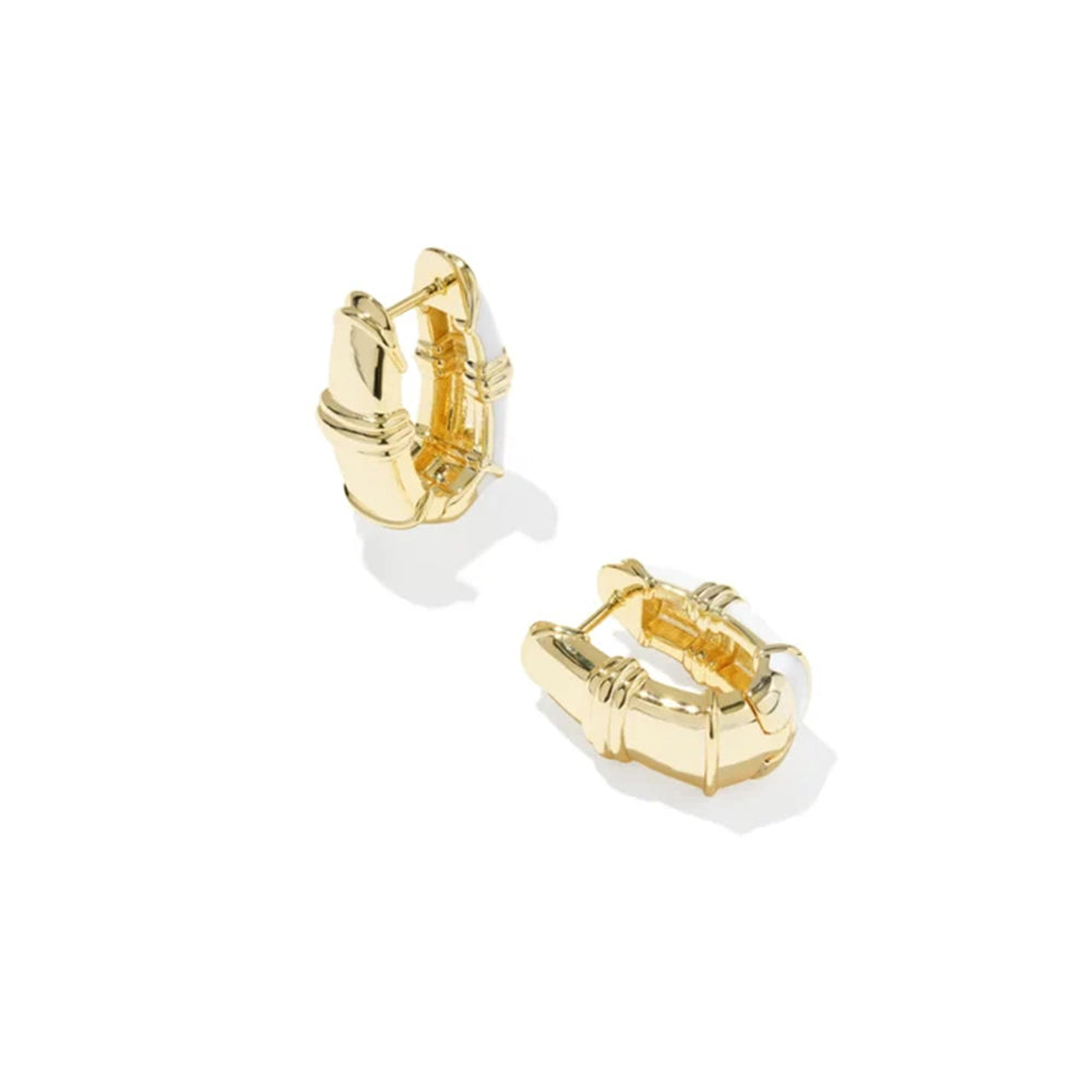 A pair of gold huggie hoop earrings with a textured, geometric bamboo-inspired design, shown on a clean white background.