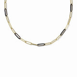 A gold paperclip chain necklace with alternating gold and black links, displayed against a solid white background.