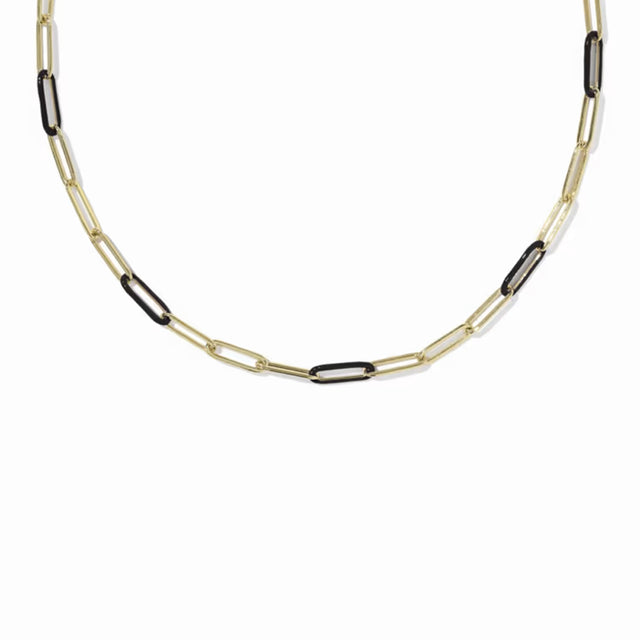 A gold paperclip chain necklace with alternating gold and black links, displayed against a solid white background.