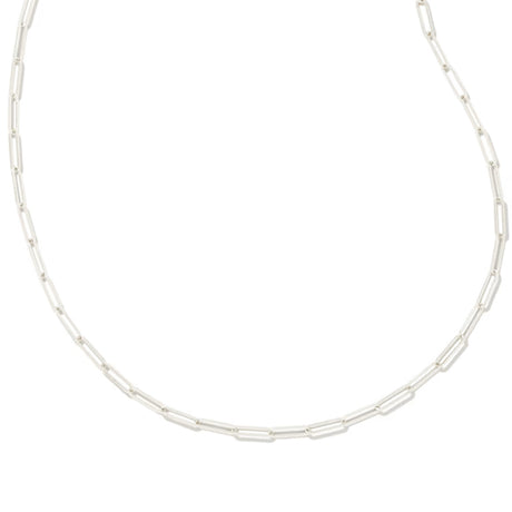 A silver paperclip link chain necklace displayed in a curved shape against a solid white background.
