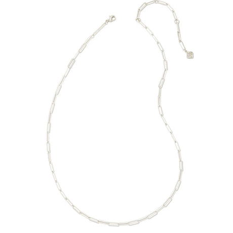 A delicate silver paperclip chain necklace with a lobster clasp and an adjustable extender chain featuring a small heart-shaped charm, displayed on a solid white background.