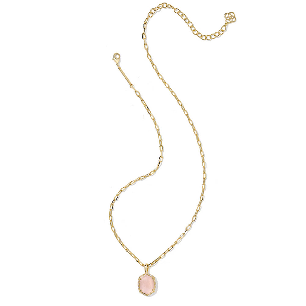 Gold necklace with a pink pendant on a white background