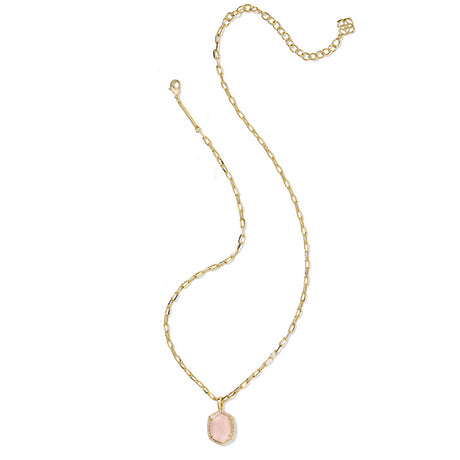 Gold necklace with a pink pendant on a white background