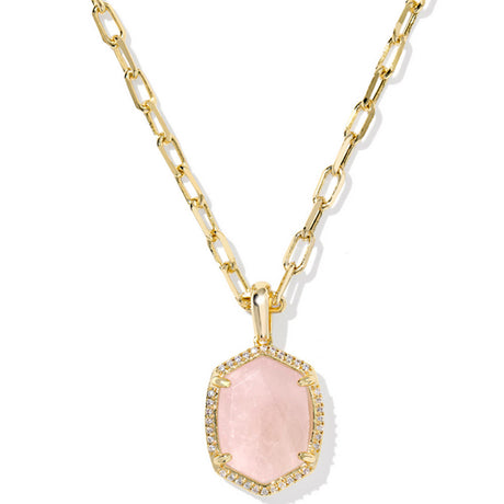 Gold necklace with a pink pendant on a white background