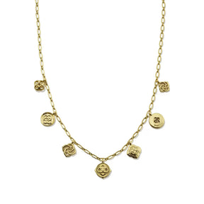 A gold chain necklace featuring multiple small dangling charms, including round medallions and textured floral or skull-like motifs, shown on a plain white background.