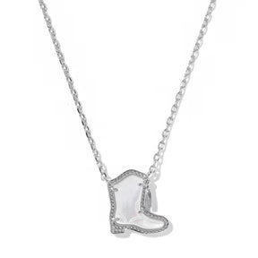 A silver-toned necklace featuring a cowboy boot pendant with a white iridescent inlay and small clear stones along the edges, shown against a plain white background.