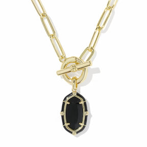A gold paperclip chain necklace with a toggle clasp and a small oval black gemstone pendant, shown on a plain white background.