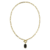 A gold paperclip chain necklace with a toggle clasp and a small oval black gemstone pendant, shown on a plain white background.