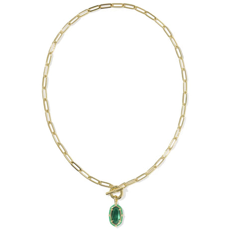A gold paperclip chain necklace with a toggle clasp and a small oval green gemstone pendant, shown on a plain white background.