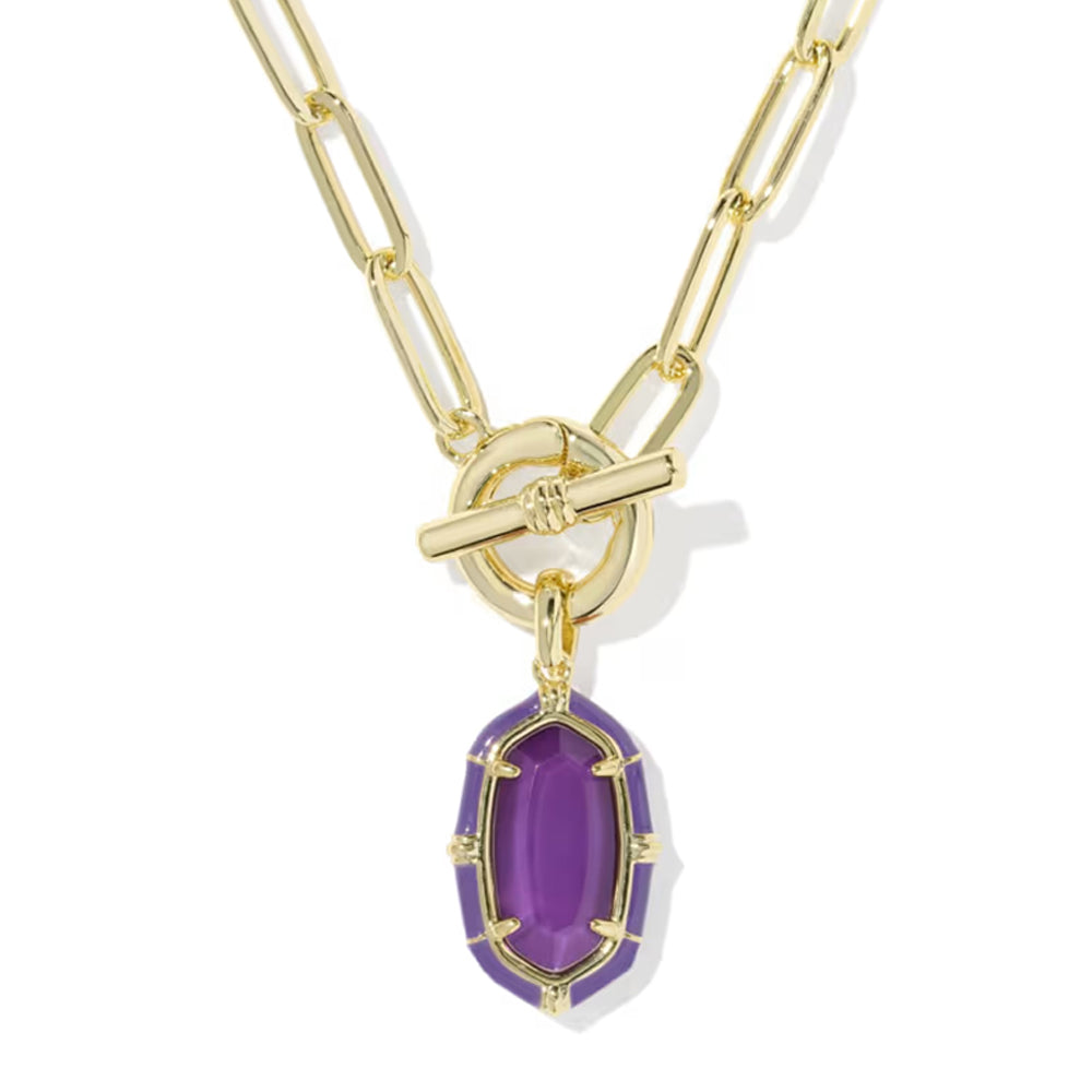 A gold paperclip chain necklace with a toggle clasp and a dangling purple faceted gemstone pendant, shown on a clean white background.
