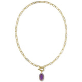 A gold paperclip chain necklace with a toggle clasp and a small purple rectangular pendant, shown on a plain white background.