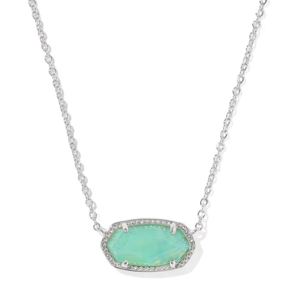 A silver-toned oval pendant necklace featuring a light green opal-like center stone surrounded by small clear pavé stones, suspended on a delicate silver chain against a white background.