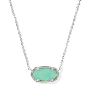 A silver-toned oval pendant necklace featuring a light green opal-like center stone surrounded by small clear pavé stones, suspended on a delicate silver chain against a white background.