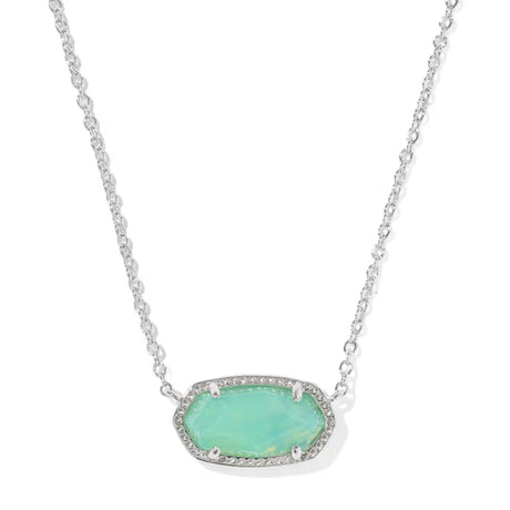 A silver-toned oval pendant necklace featuring a light green opal-like center stone surrounded by small clear pavé stones, suspended on a delicate silver chain against a white background.