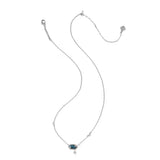 A delicate silver chain necklace featuring a small rectangular dark blue gemstone pendant and a tiny silver cross charm below it, displayed on a solid white background.