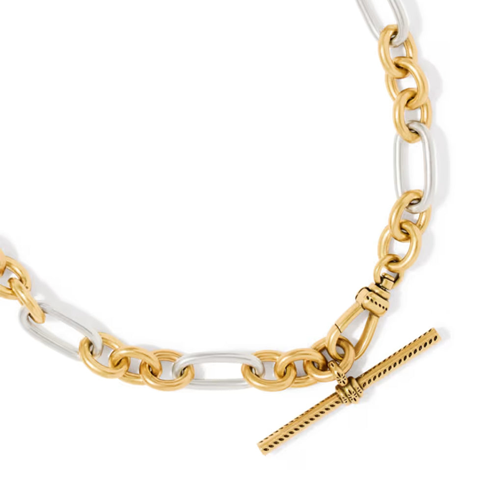A close-up of a two-tone chain necklace featuring alternating polished gold and silver paperclip links, with a gold toggle clasp on a white background.