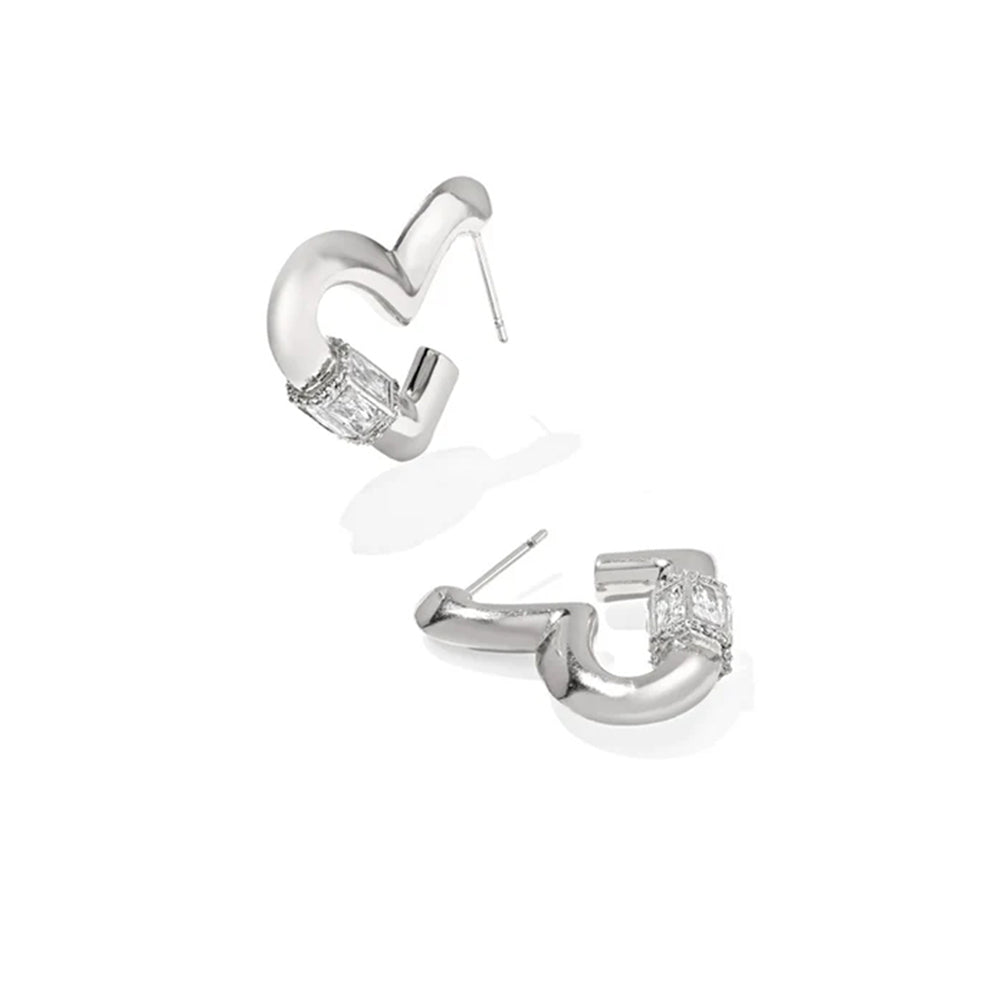A pair of silver-toned C-shaped hoop earrings with a clear rectangular gemstone at the front, shown on a clean white background.