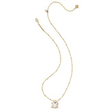 Gold necklace with a small white pendant on a white background