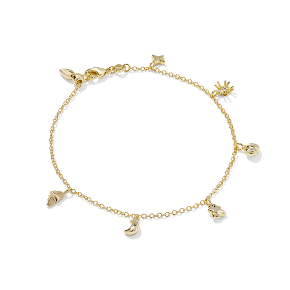 Gold bracelet with various charms on a white background