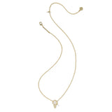 A delicate gold chain necklace featuring a small pendant with a white inlay, displayed on a clean white background.
