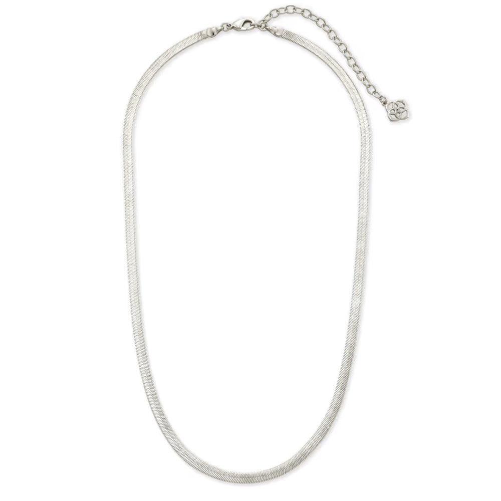 A silver-toned snake chain necklace with a small circular engraved charm, displayed on a clean white background.