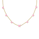 Necklace with pink butterfly pendants on a gold chain against a white background