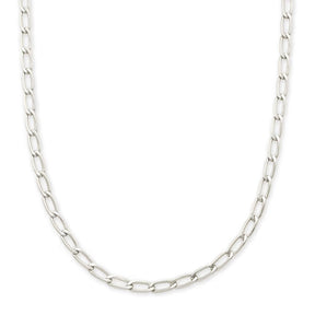 A silver Figaro chain necklace with polished oval links, displayed in a curved shape against a solid white background.