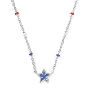A silver-toned star pendant necklace with a blue inlay, accented by small red and blue beads on a white background.