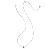 A delicate silver-toned chain necklace featuring a small blue star charm at the center, accented with tiny red and blue beads, displayed on a solid white background.