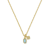 A gold chain necklace featuring a small oval light blue gemstone pendant and two small gold charms, displayed on a clean white background.