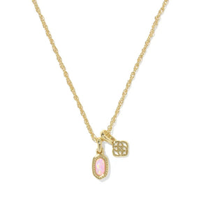 A gold chain necklace featuring two charms: a small oval pink opal-like stone pendant and a small gold filigree flower charm, shown on a plain white background.