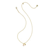 A delicate gold chain necklace featuring a small oval pink gemstone pendant and a tiny gold charm, displayed on a clean white background.
