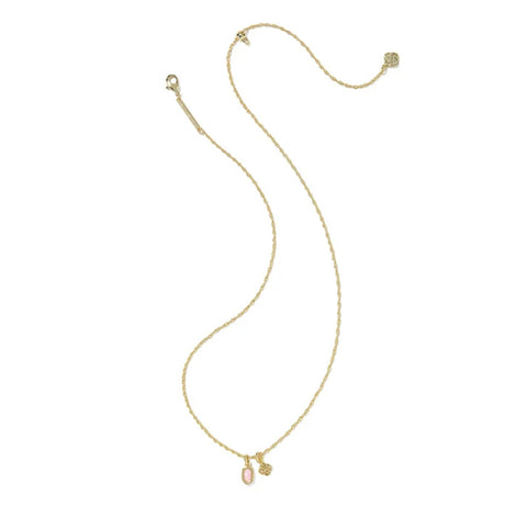 A delicate gold chain necklace featuring a small oval pink gemstone pendant and a tiny gold charm, displayed on a clean white background.