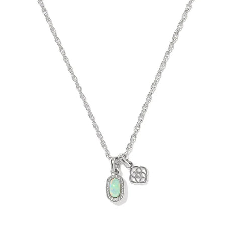 A silver chain necklace featuring an oval pendant with a light green opal-like center surrounded by small clear stones, alongside a small geometric charm, shown on a plain white background.