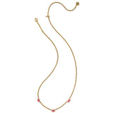 Gold necklace with pink stones on a white background