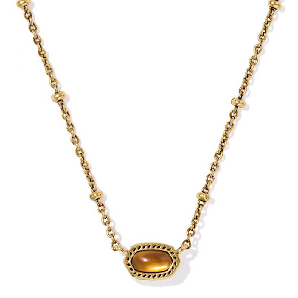 Gold necklace with a tiger's eye pendant on a white background