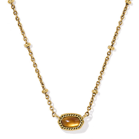 Gold necklace with a tiger's eye pendant on a white background